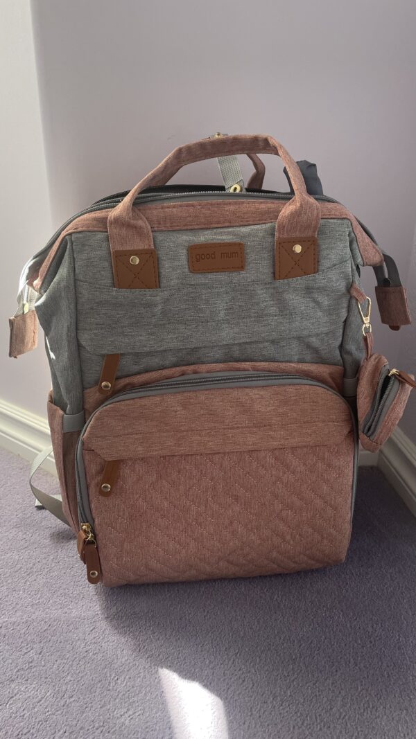 Diaper bag with detachable changing pad